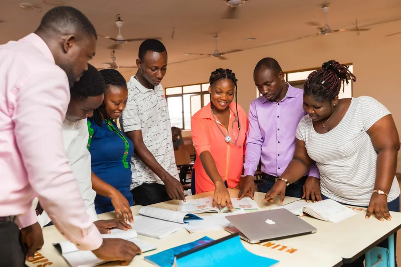 Students collaborating with laptops